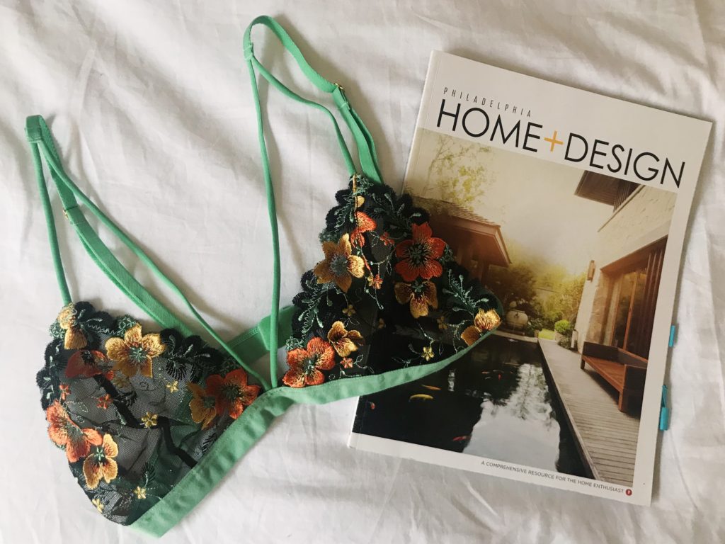 Philadelphia Home and Design magazine with a floral bralette from Urban Outfitters. Flat lay photograph